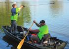 Group cleaning City Park pond pull debris, rescue turtle during event