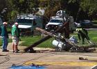 Garbage truck pulls down power line
