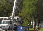 Garbage truck pulls down power line